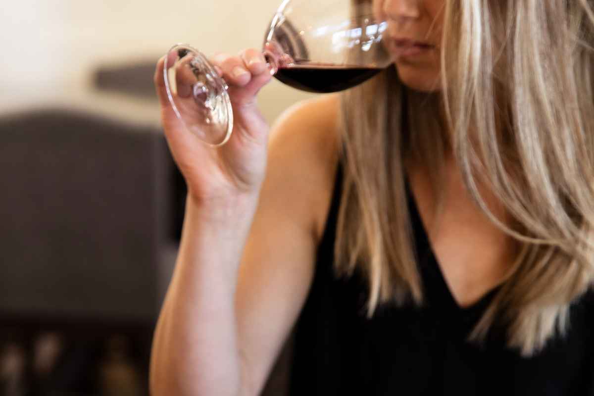 smelling a glass of wine